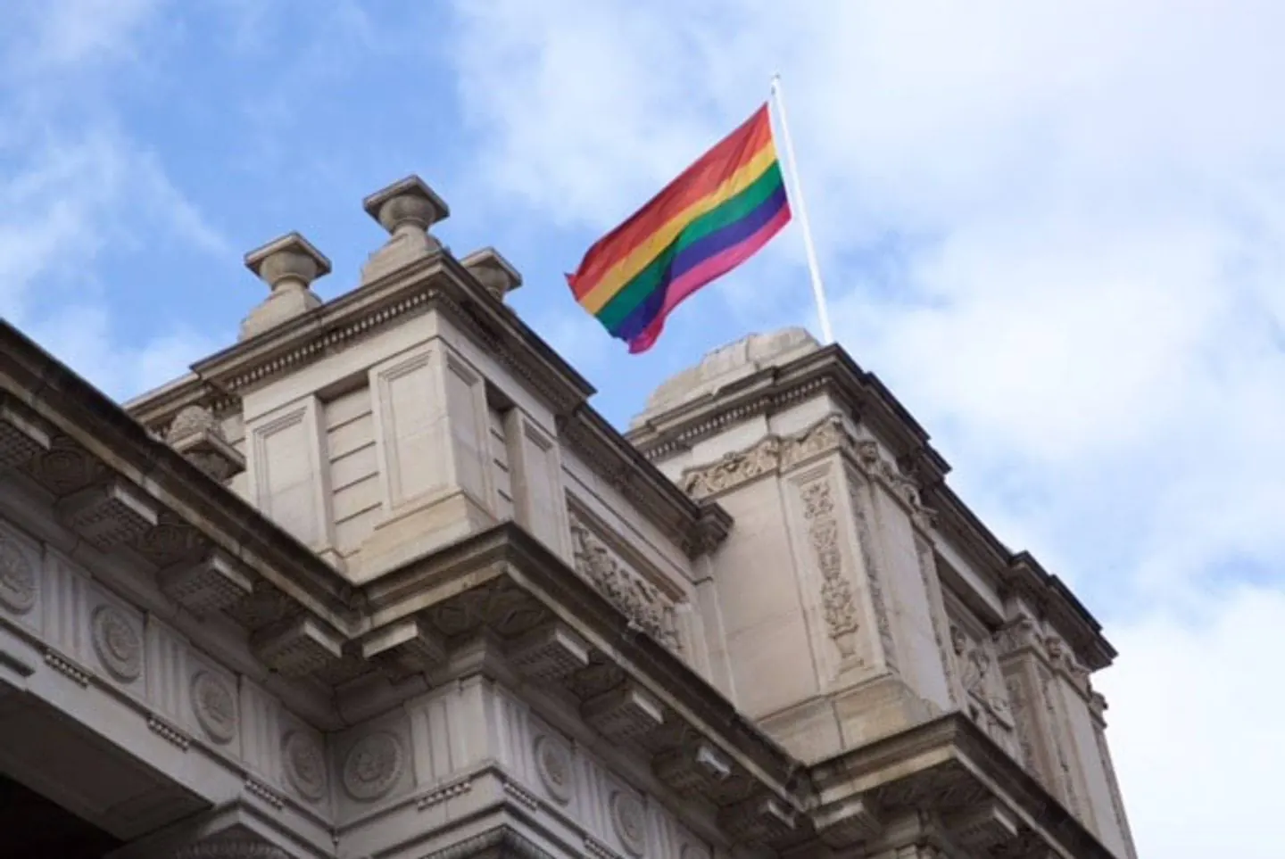 The rainbow flag flying over the Victorian Parliament